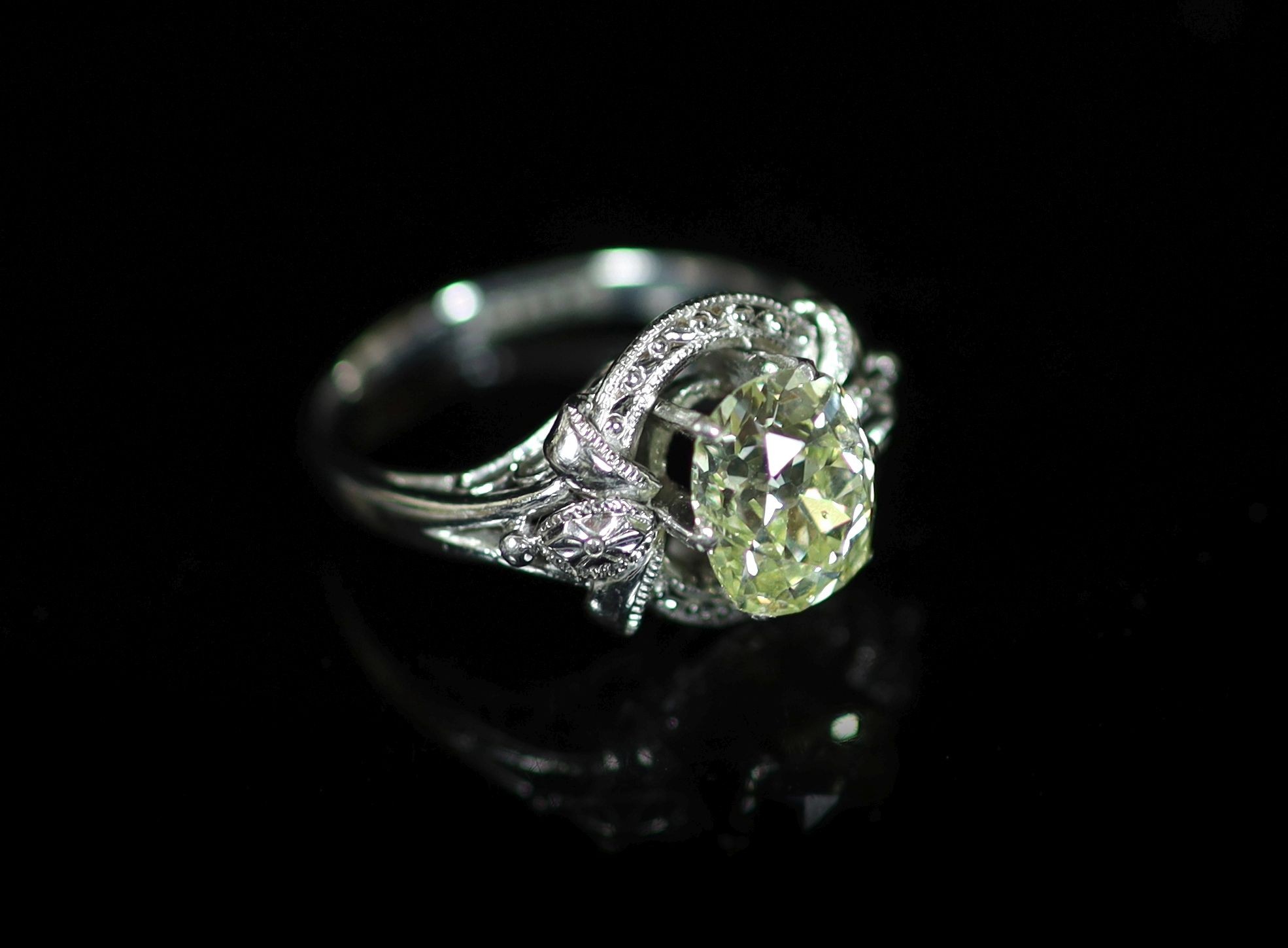 A white gold and oval cut solitaire diamond ring, in a raised claw setting